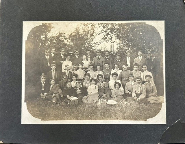 Vintage group portrait, early 1900s, with Grace Gudith seated in the second row, center